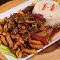 Lomo Saltado Mixto · Traditional Peruvian stir-fry, with seasoned strips of steak and chicken, onions and tomatoe...