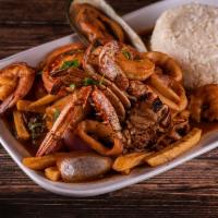 Saltado de Mariscos · Traditional Peruvian stir-fry, with shrimps, crab, calamari, mussles red onions and tomatoes...