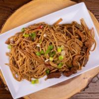 Tallarines Saltado Mixto · Homemade Peruvian stir-fried linguine sautéed with strips of chicken, steak and red bell pep...