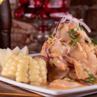 Ceviche De Pescado · Fresh sliced fish fillet marinated in lime juice and infused with red onions. Accompanied wi...