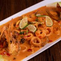 Pescado A Lo Macho · Two fried fish with creamy calamari, mussels, shrimps, and crab seafood sauce on top. Accomp...