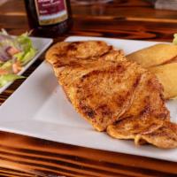 Pechuga A La Parrilla · Chicken breast marinated in our special parrilla sauce and cooked on a charcoal grill with y...