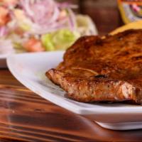 Chuleta A La Parrilla · Two prime pork chops marinated in our special parrilla sauce and cooked on a charcoal grill ...