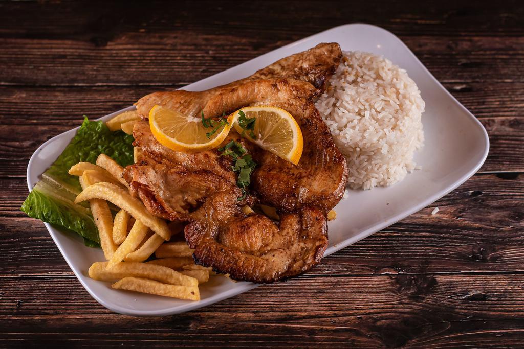 Pechuga La Plancha · Seasoned chicken breast fried on a skillet, accompanied with French fries, white rice, and topped with cilantro.
