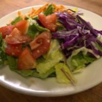 Garden Salad · Romaine lettuce, Roma tomatoes, carrot, cabbage, croutons with your choice of dressing.