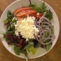 Greek Salad · Spring mix, Kalamata olives, red onion, Roma tomato, feta cheese served with Greek Dressing.