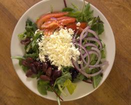 Greek Salad · Spring mix, Kalamata olives, red onion, Roma tomato, feta cheese served with Greek Dressing.