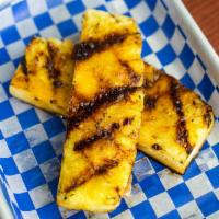 Grilled Pineapple Steaks · Two big, juicy slices grilled and seasoned with cayenne and raw cane sugar for a touch of sw...