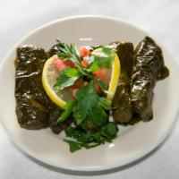 Grape Leaves · Hand rolled grapevine leaves stuffed with rice, tomatoes, onions, parsley and meticulously p...