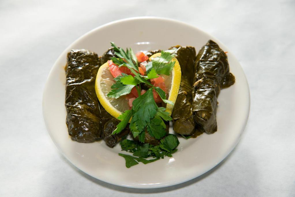 Grape Leaves · Hand rolled grapevine leaves stuffed with rice, tomatoes, onions, parsley and meticulously picked spices. Vegan.