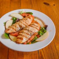 Grilled Salmon Salad · It contains mixed greens, romaine lettuce, carrots, cucumbers, and apples.