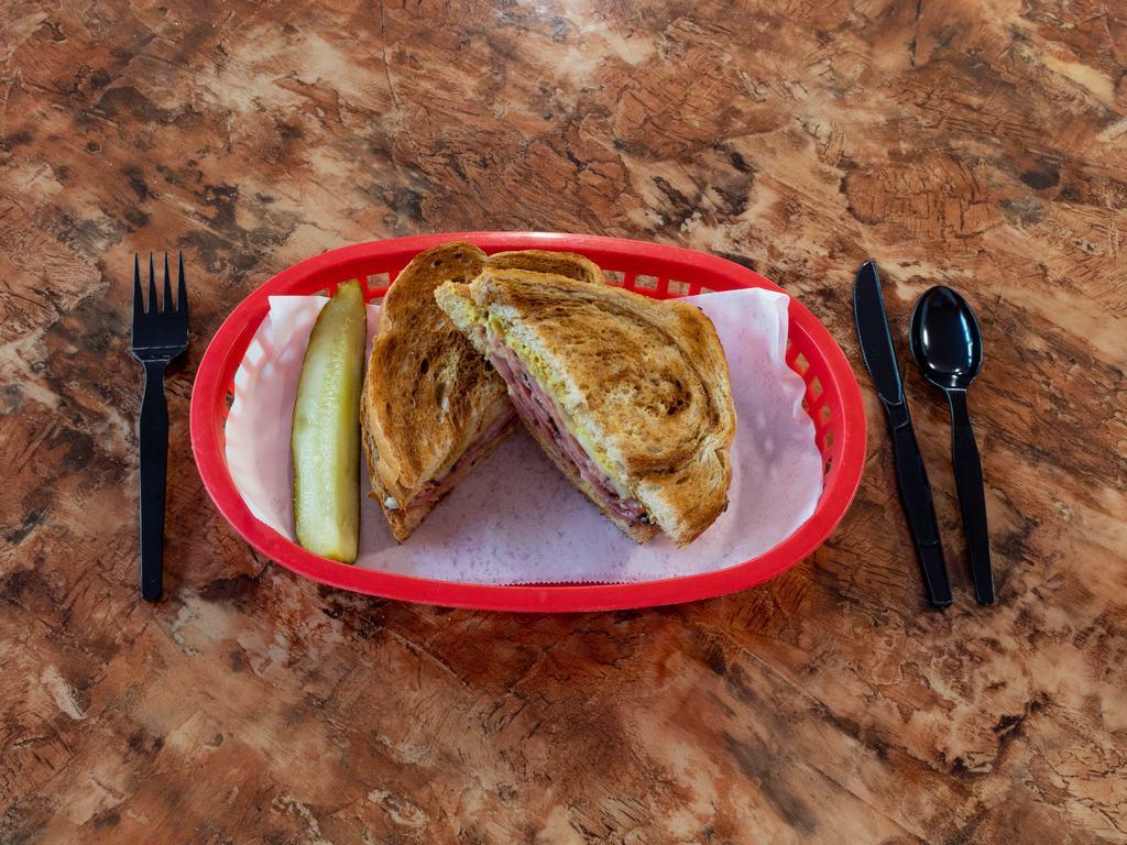 Classic Pastrami and Swiss Sandwich · Pastrami topped with Swiss and deli mustard, on marble rye with a pickle spear.