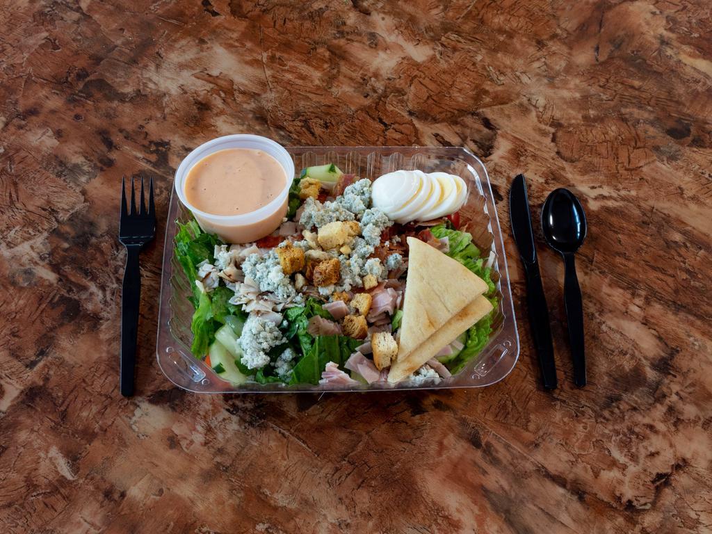 Cobb Salad · Turkey, ham, bacon crumbles, hard boiled egg, blue cheese crumbles, shredded carrots, cucumbers, tomatoes, pepperoncini and lettuce with Athenian feta dressing.