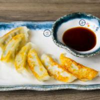 Gyoza · 6 pieces pan fried pork with veggie stuffing with house special sauce.