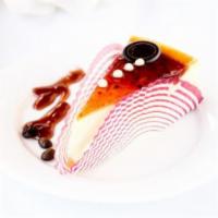 Cheese Cake · Slice of cheese cake with a layer of raspberry jam on top