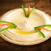 Hummus · Chickpeas dip with tahini, garlic, lemon juice and olive oil. Vegan.