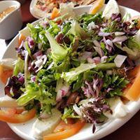 Caprese · Fresh mozzarella, sliced tomato, sliced red onion, fresh basil leaves, and kalamata olives o...