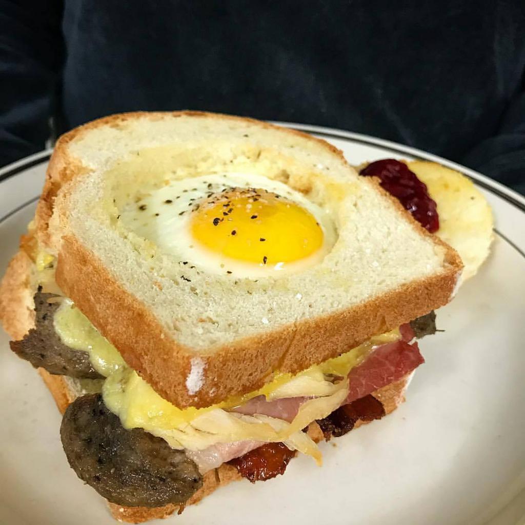 One Eyed Willie · Breakfast sandwich served on our house made bread with a locally sourced egg nested in the top slice with cheddar.