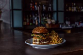 Burger + Fries · Flame broiled burger, brioche bun, lettuce, tomato, pickles and fries.