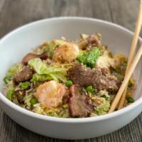 Yang Chow Fried Rice · Blend of steamed rice stir-fried with fresh lettuce, egg, scallions, onions, peas