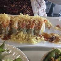 Happy Roll · In shrimp tempura, crab, cucumber. Out assorted chopped fish, tempura bits, eel sauce.