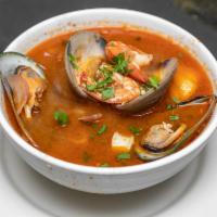 Parihuela · Variety of seafood (scallop, octopus, calamari, shrimp, mussels, crab) and fish, all cooked ...