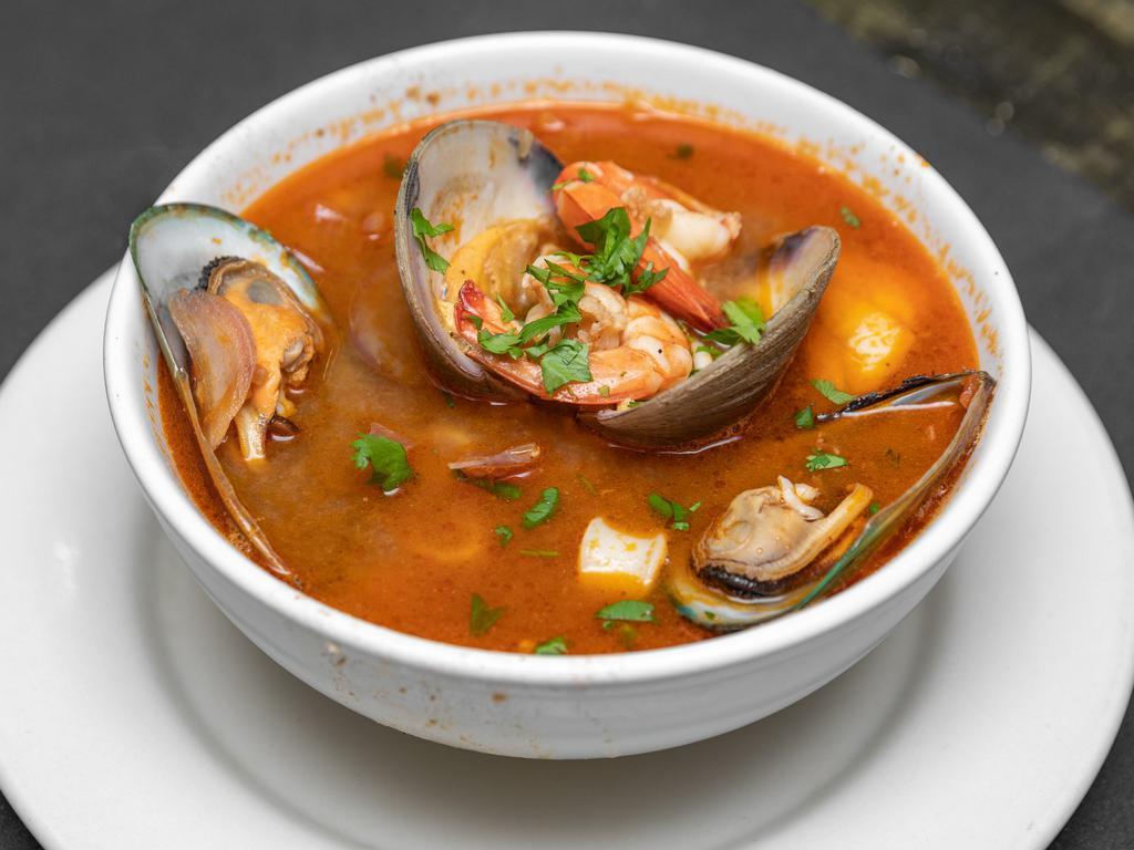 Parihuela · Variety of seafood (scallop, octopus, calamari, shrimp, mussels, crab) and fish, all cooked in a fish consomme.