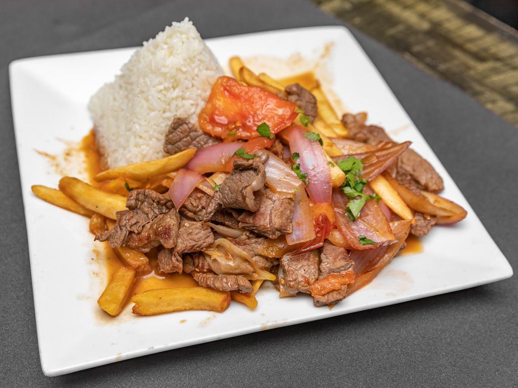 Lomo Saltado a Lo Pobre · Santeed chunks of beef with red onions and tomatoes served with rice, sweet plantain, and fried egg.