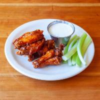 Spicy Chicken Wings · 1 lb. of wings and drumettes tossed in our own house hot sauce. Served with blue cheese dres...