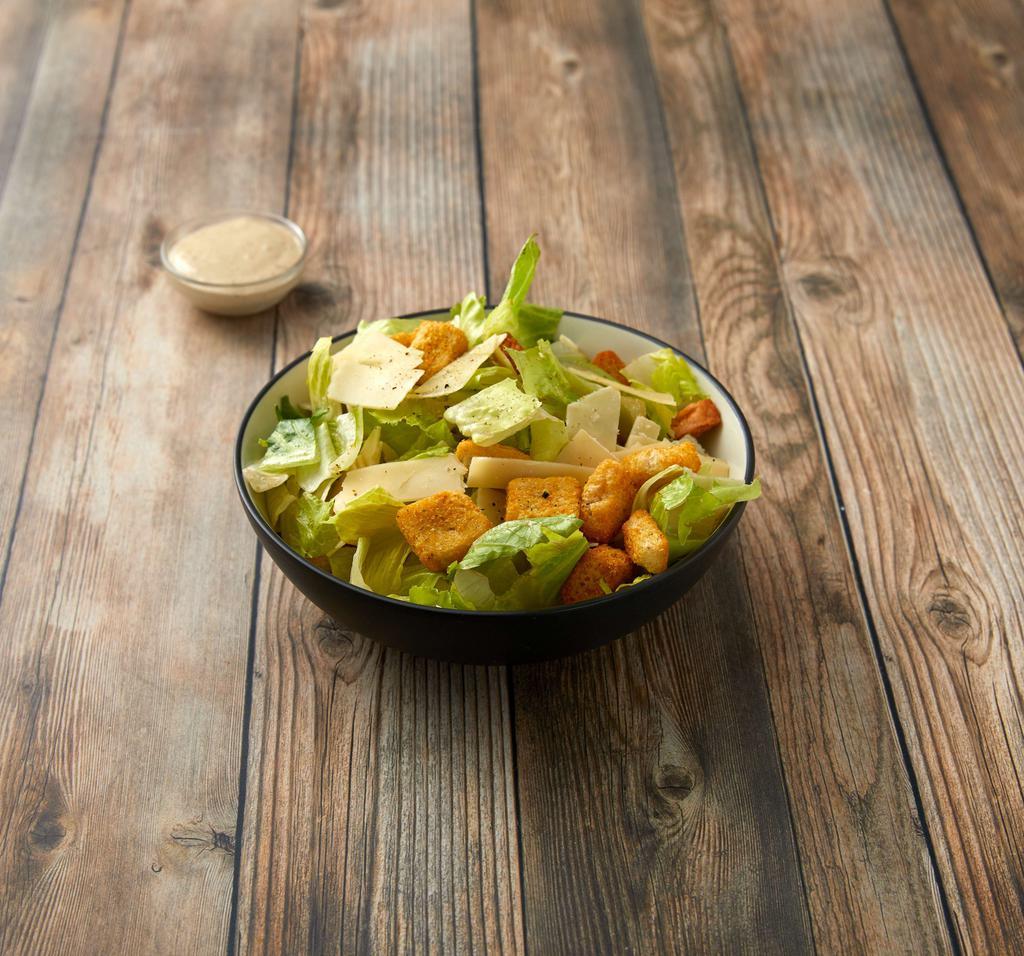 Insalata di Cesare · Hearts of romaine with croutons and traditional caesar dressing and shaved parmigiano.