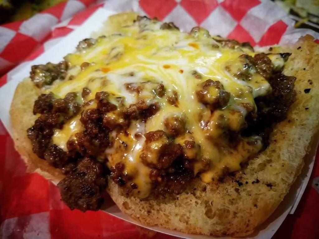 Open Face Chili Cheese Burger · 4 oz. of fresh-made chili, 3 oz. of hot melty fresh sliced cheddar cheese, served on top of a 5 oz. fresh seared hamburger patty (never premade) then topped with mustard and onions!!!