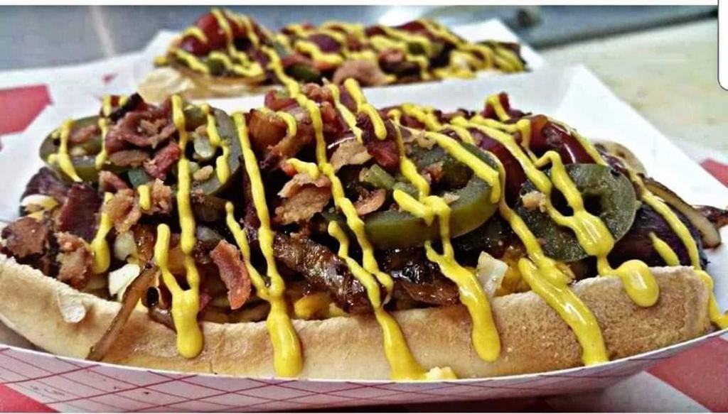 Loaded Polish · Polish dog topped with cheddar, caramelized onions, bacon, mustard, ketchup, and jalapeños! 