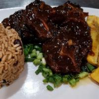 Braised Oxtails · Perfectly tender chunks of oxtails smothered in our delicious house made brown gravy with bu...
