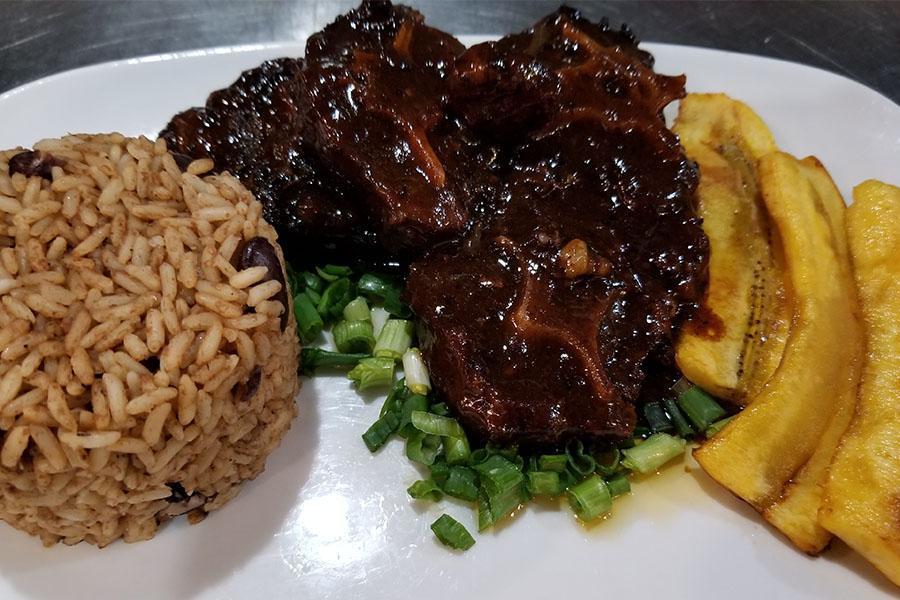 Braised Oxtails · Perfectly tender chunks of oxtails smothered in our delicious house made brown gravy with butter beans.