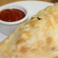 Cheese Calzone (Build Your Own) · Stuffed pizza with ricotta, mozzarella, marinara sauce. Build your own calzone by add toppin...
