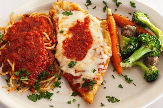 Chicken Parmigiana · Chicken breast breaded, pounded, and lightly fried and topped with Marinara and mozzarella. Includes a side of pasta and vegetables.