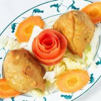 2 Vegetable Samosas · Traditional triangular patties stuffed with potatoes and peas.
