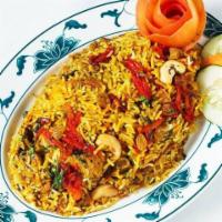 Chicken Biryani · Basmati rice flavored with saffron, cooked with mildly spiced chicken in an aromatic combina...