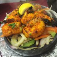 Tandoori Shrimp · Scrumptious jumbo shrimp marinated in an exotic blend of Indian spices and then cooked on sk...