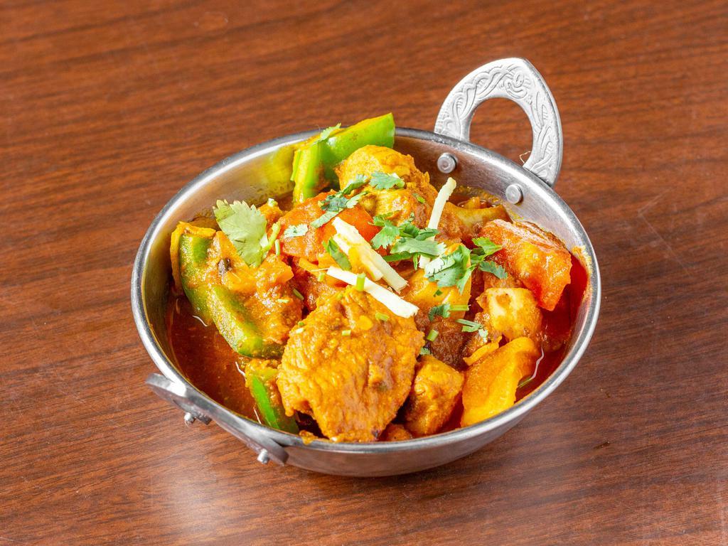 Kadai Chicken · Chicken cooked with an exotic blend of curry spices, onion, garlic, ginger and tomato with a medium thick sauce. Served with aromatic basmati rice.