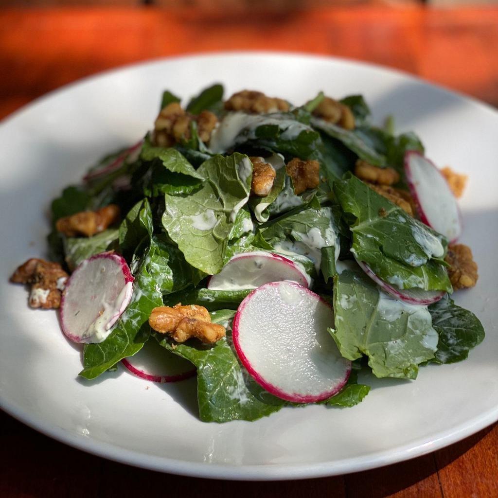 Kale Salad · baby kale and shaved radishes, scipy walnuts and basil buttermilk dressing drizzled with acacia honey. 