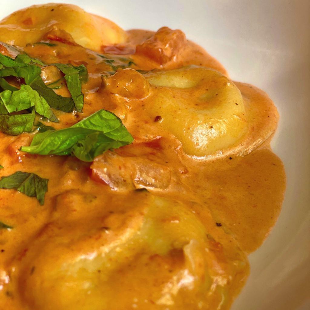 Tuscan Bean Ravioli · Fresh ravioli with a hearty filling of ricotta and cannellini beans, served in a tomato-cream sauce.

