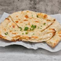 Kabuli Naan · Naan baked in clay oven with nuts, raisins, and chemises.
