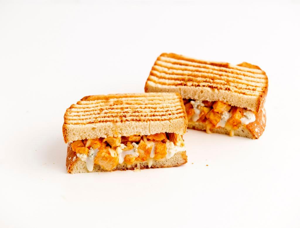 Buffalo Chicken Melt · A sandwich so hot . . . it's cool! This Panini Melt is made with spicy-hot Grilled Buffalo Chicken and melty-cheesy Mozzarella Cheese. It is cooled down with Bleu Cheese dressing and served warm between two slices of our buttered-toasted Rustic White bread.