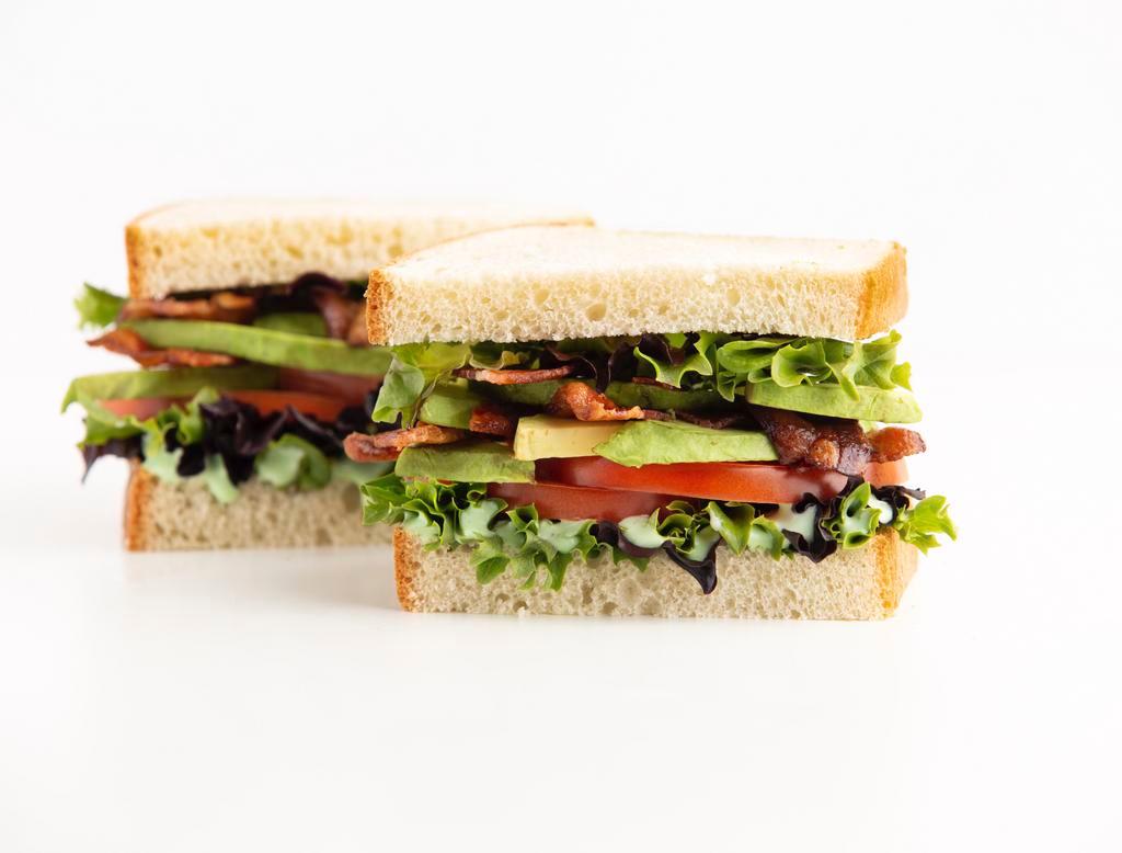 Avocado BLT Sandwich · Enjoy our version of a timeless favorite! We're adding Fresh-sliced Avocado and our Green Goddess dressing to take the classic Bacon, Lettuce &Tomato sandwich to a whole new level! Served between two slices of our delicious Rustic White bread.