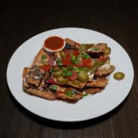 Irish Nachos · House-made boxty chips smothered in our creamy 3-cheese sauce and topped with scallions, tom...