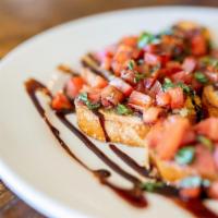 Bruschetta · Toasted bread rubbed with garlic butter with a topping of diced tomatoes and fresh basil in ...