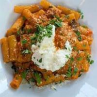 Rigatoni Ragu · Ground sausage and dry porcine meat sauce, topped with whipped ricotta and parmigiano cheese