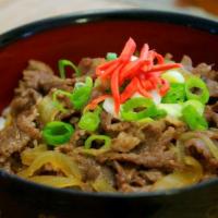 Gyu Don牛肉饭 · Thinly sliced beef and onion, eggs, over rice.