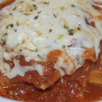 Chicken Lasagna · Layers of lasagna sheets alternated with sauce, grilled chicken, and cheese.   Served with b...